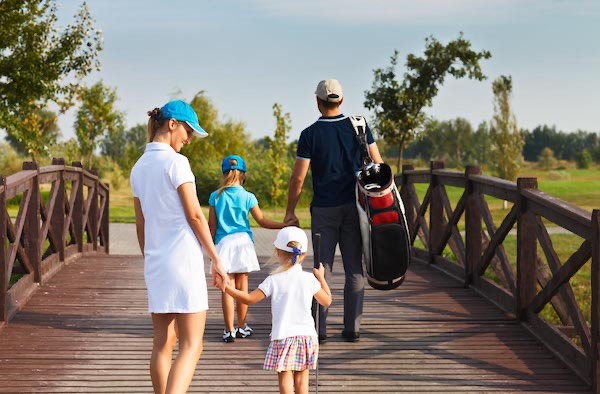 Family enjoying a sunny golf course